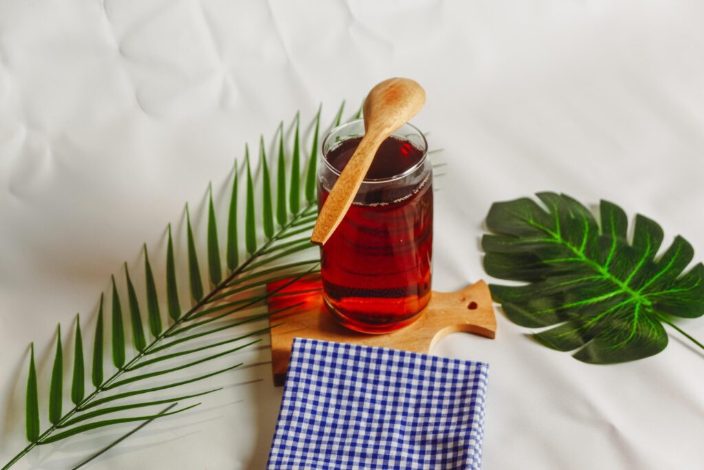 photography of a glass of tea and several elements on a white background Stock Free