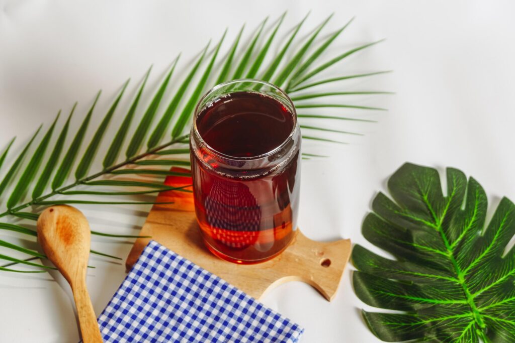 photography of a glass of tea and several elements on a white background Stock Free