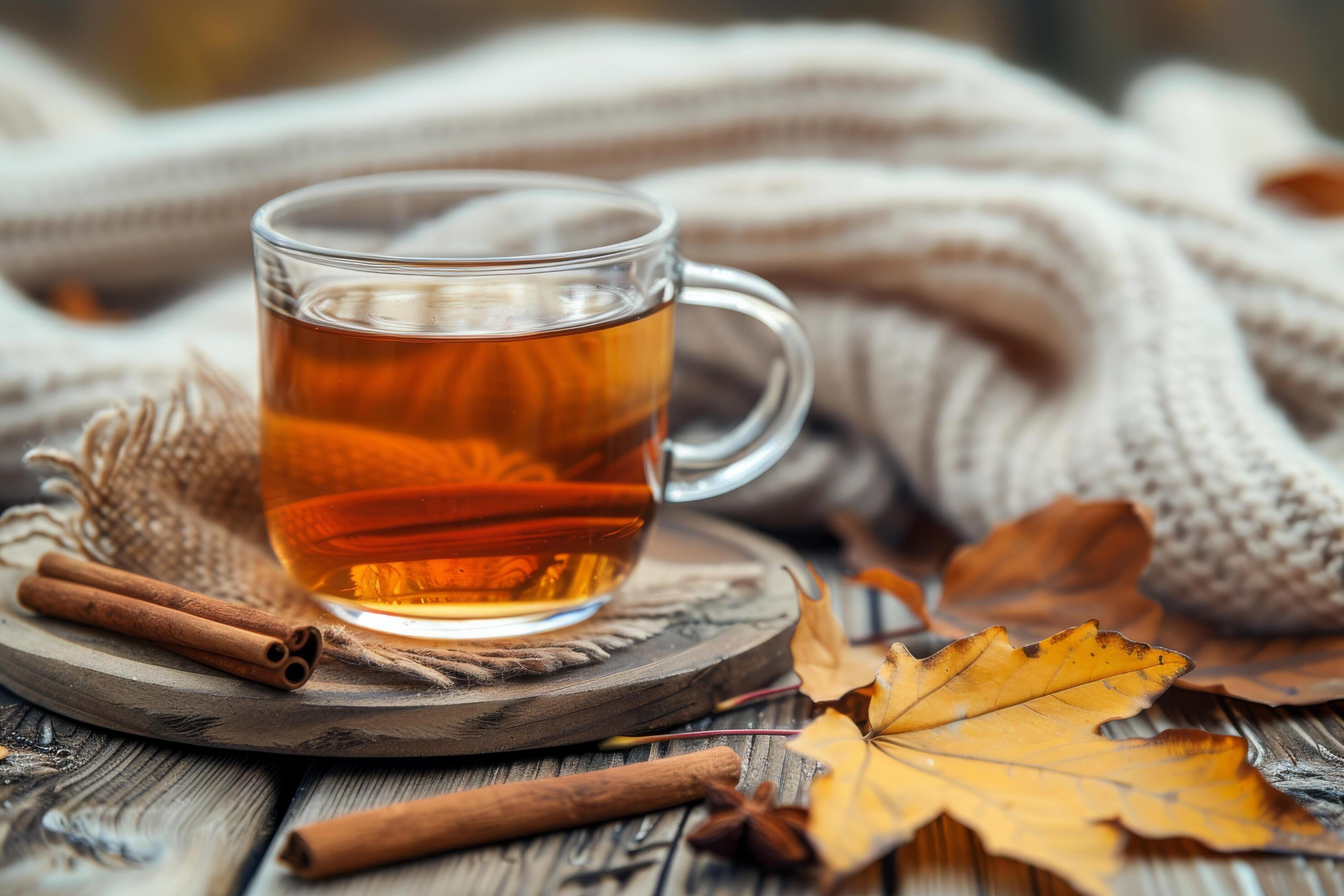 Warm Autumn Tea With Cinnamon Stick and Fall Leaves on Wooden Table Stock Free