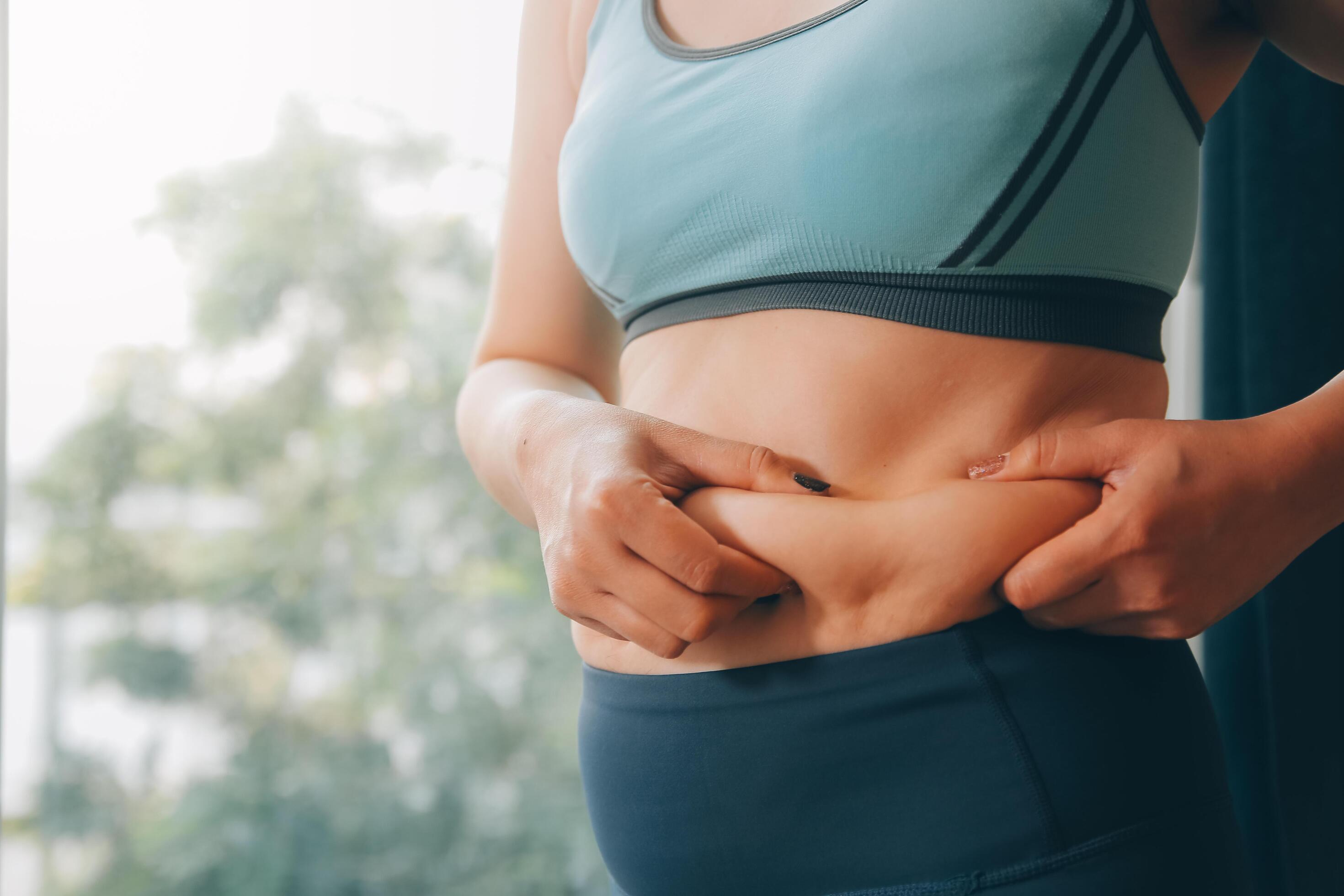 fat woman, fat belly, chubby, obese woman hand holding excessive belly fat with measure tape, woman diet lifestyle concept Stock Free