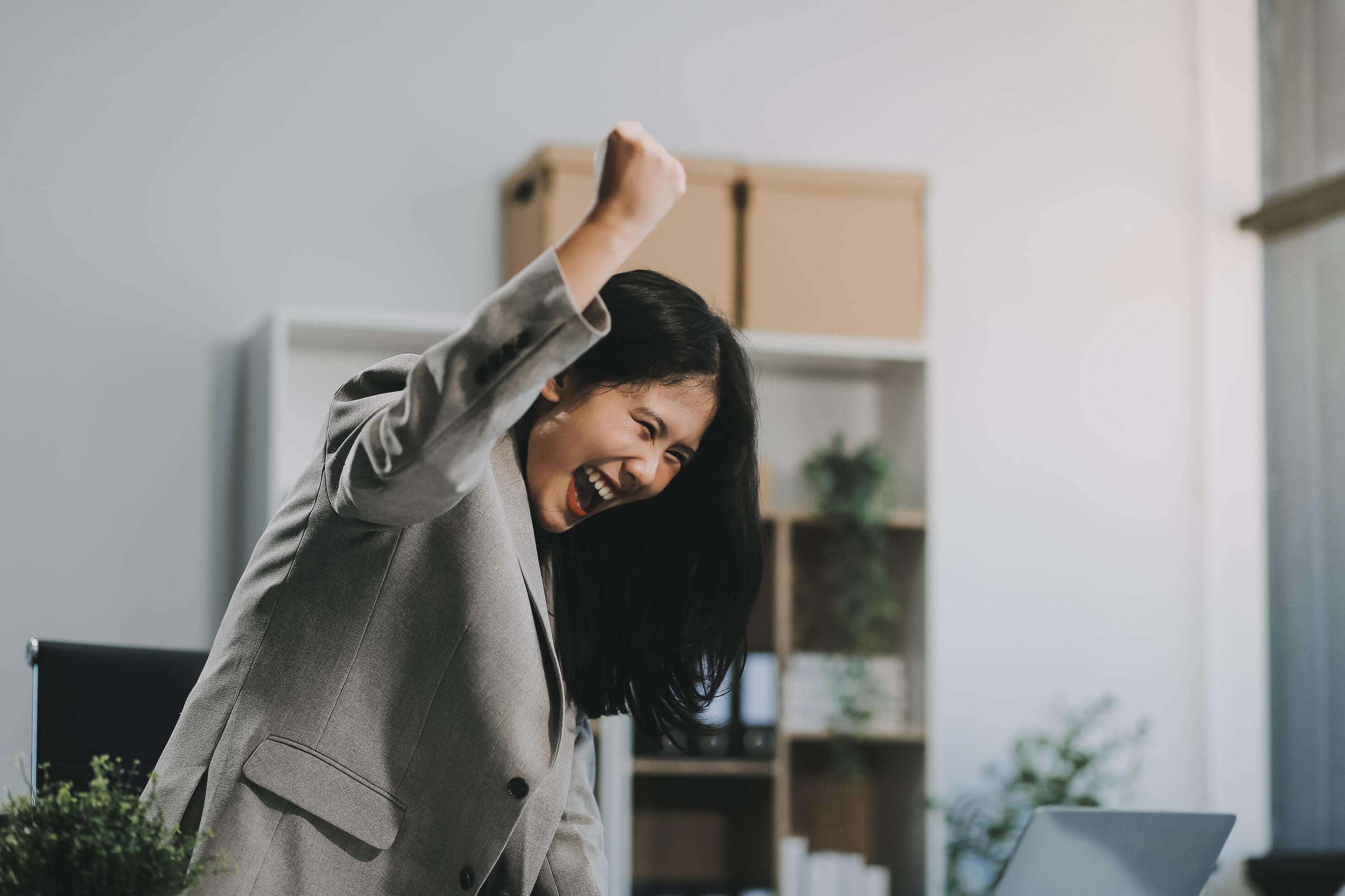 Happy executive sales business woman cheering excited in celebration after good news. achieving goals, success concept Stock Free