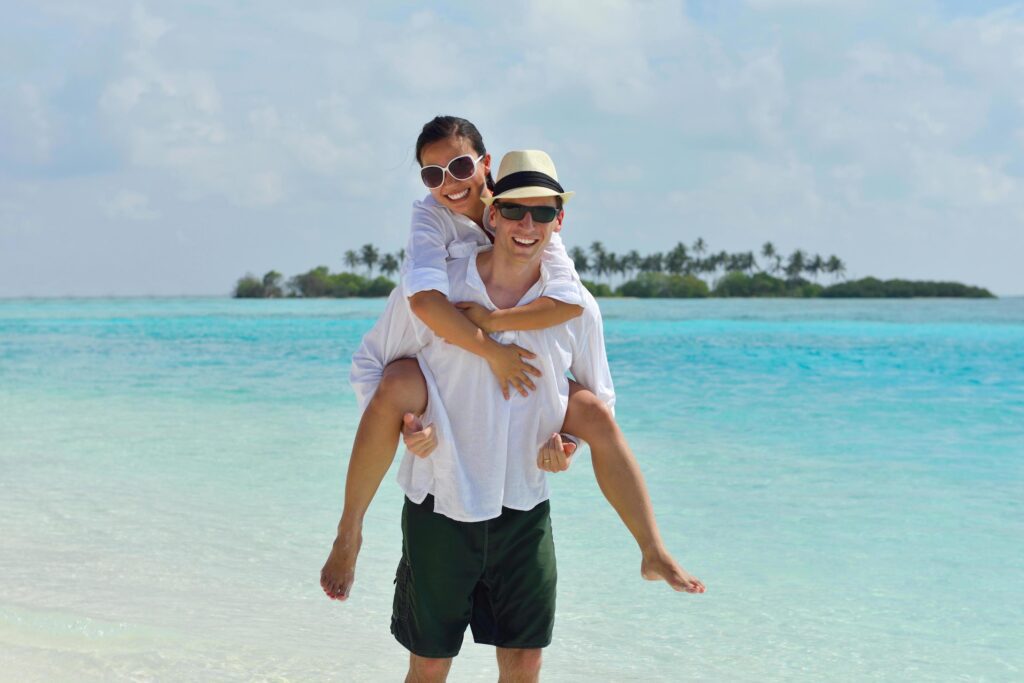 happy young couple have fun on beach Stock Free