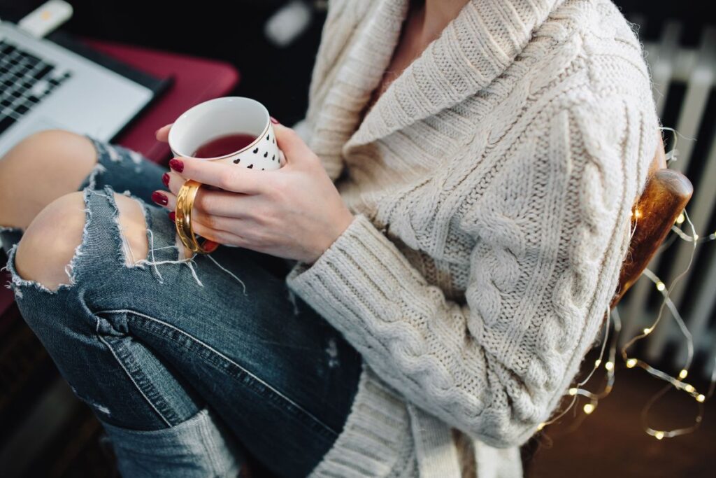 Woman drinking hot tea in her home office Stock Free