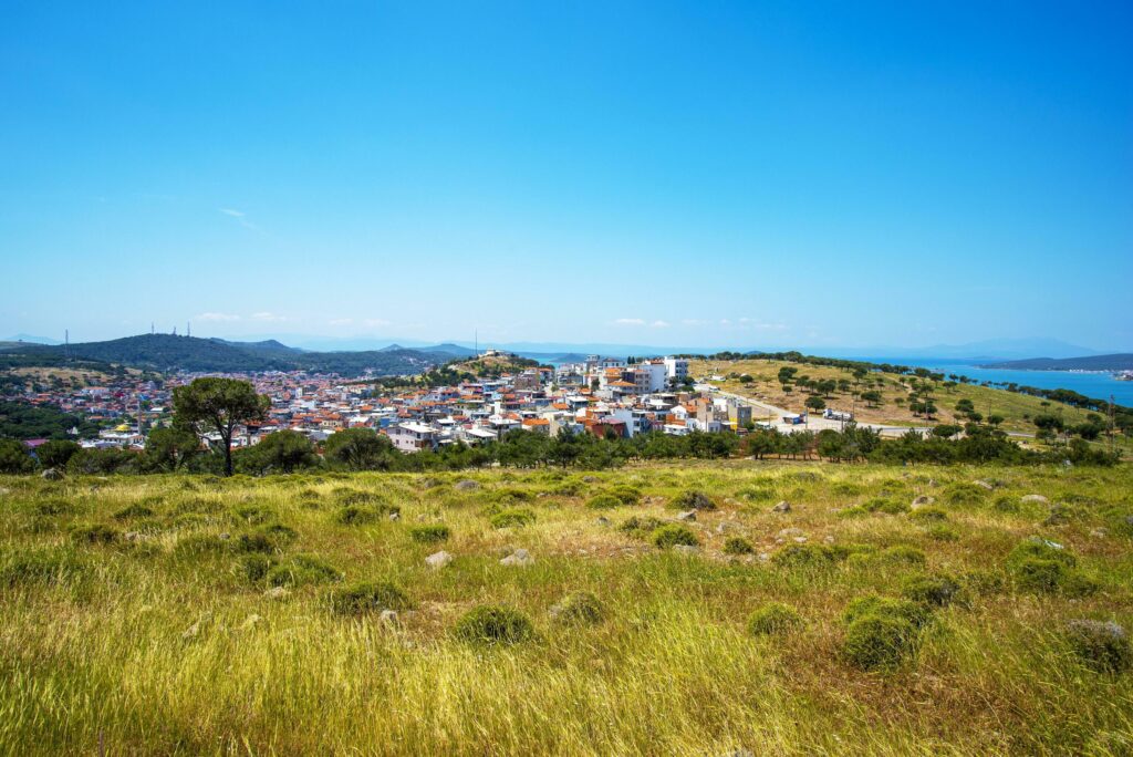 A Turkish small town overlooking the sea and a green field on a summer and sunny day. Stock Free