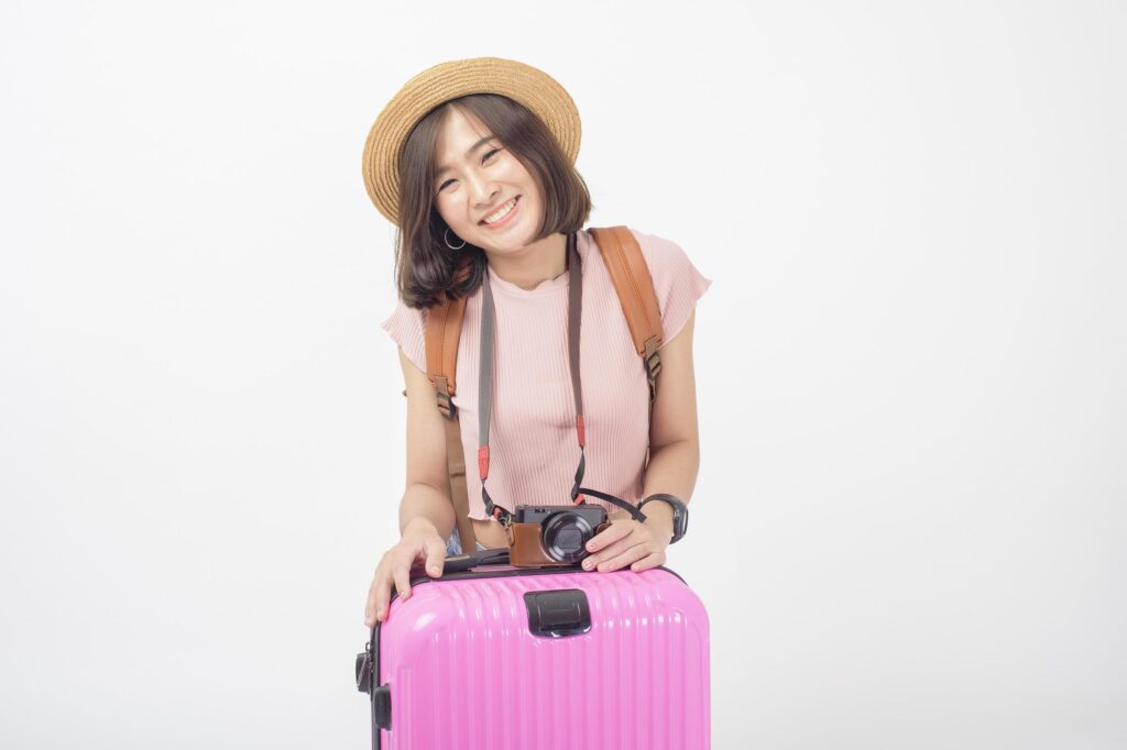 Beautiful young asian tourist woman happy on white background studio Stock Free