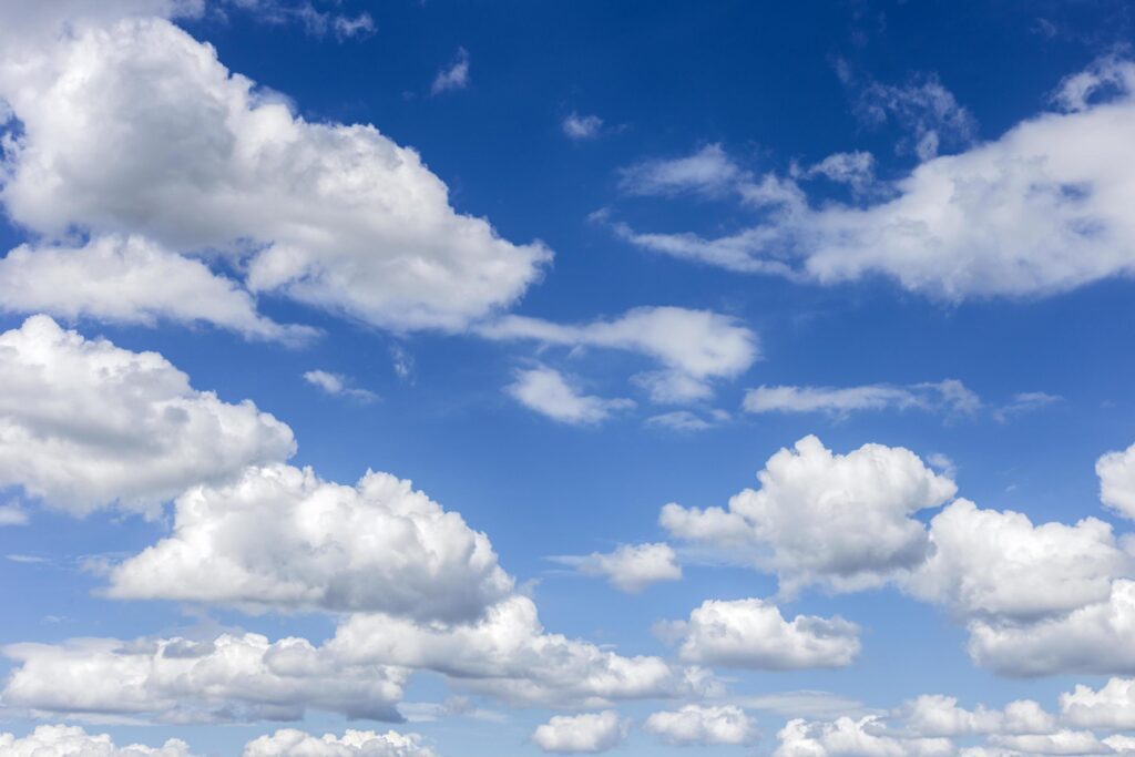 clear blue sky with plain white cloud with space for text background. The vast blue sky and clouds. blue sky background with tiny clouds nature. Stock Free