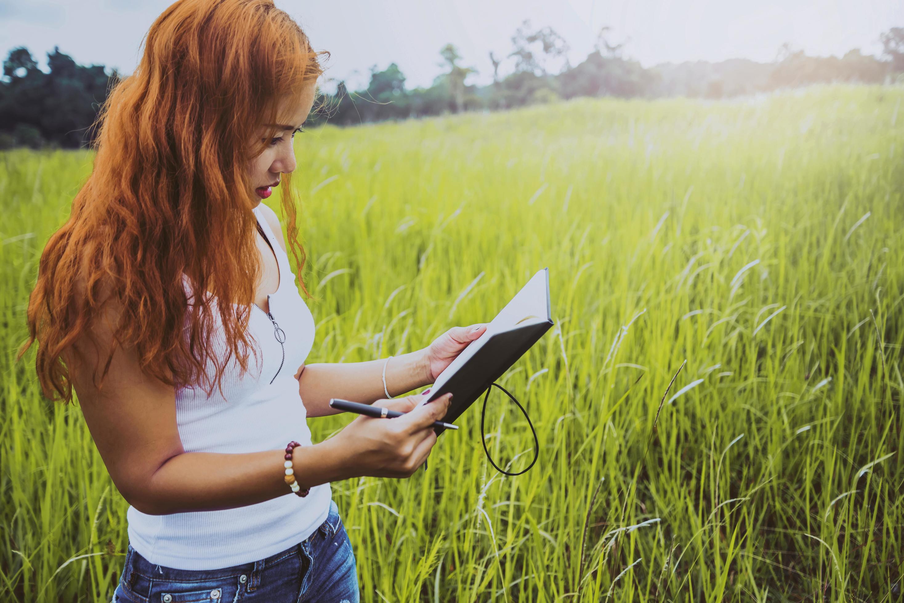 Women write notes Nature trails, mountains, forests. Writer. Asian women Stock Free