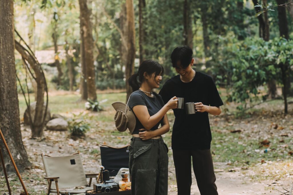 Asian couple sweet in tent inside on they camping trip, traveller relax and sleep togather in out door and camping trip Stock Free