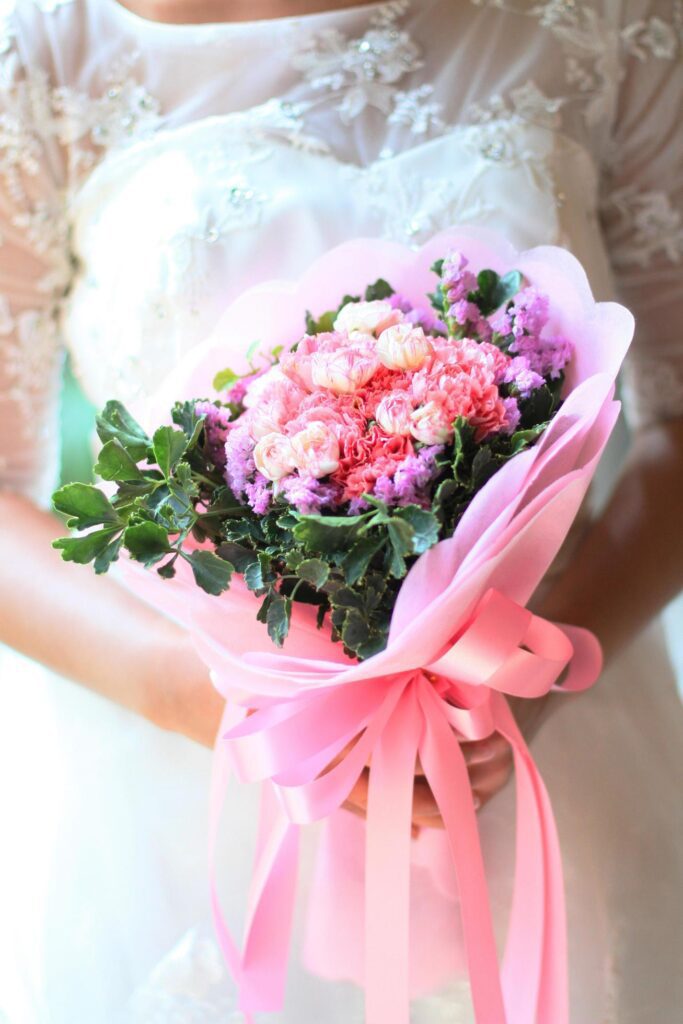 Bride holding a beautiful bouquet flowers Stock Free