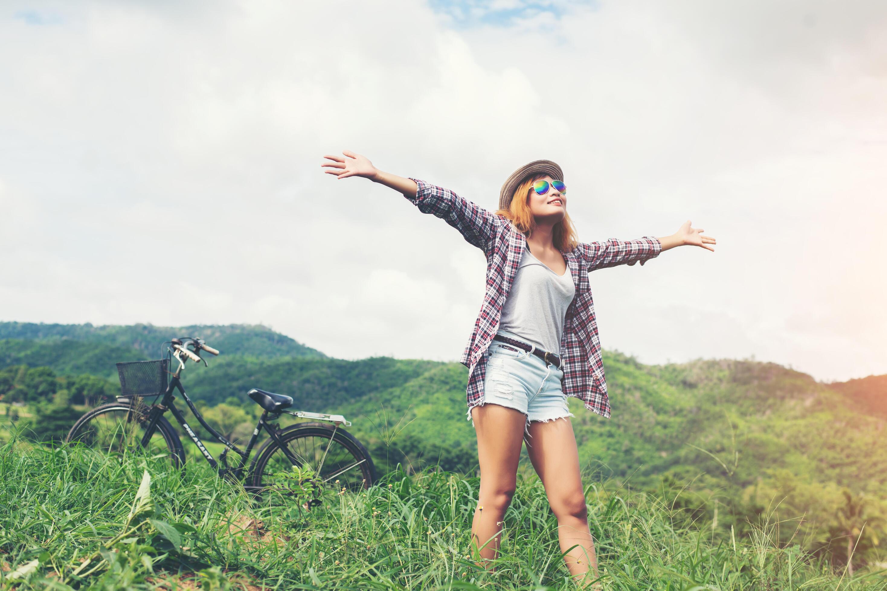 Young beautiful woman enjoying freedom and life in nature behind the mountain. Stock Free