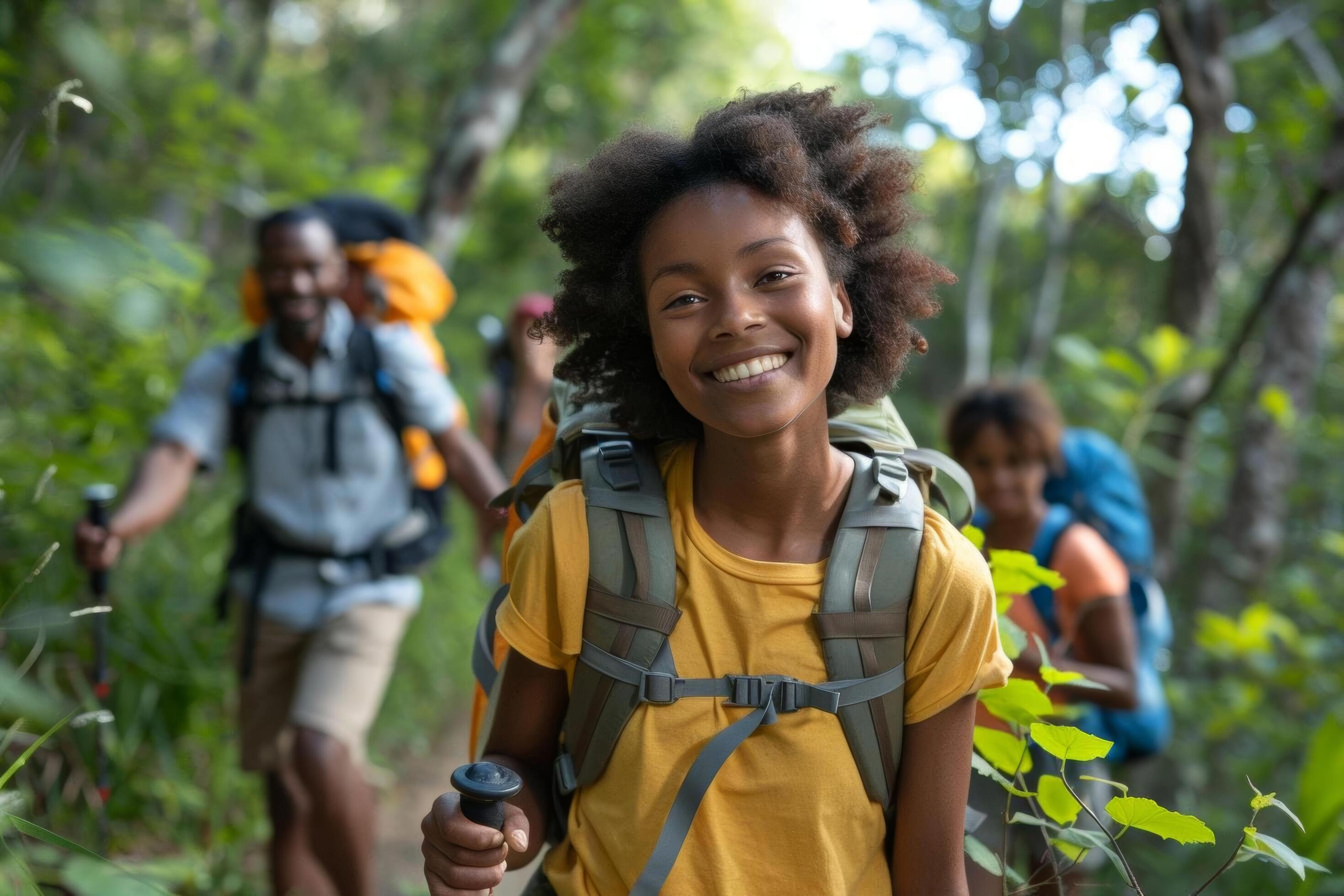 A family hiking on a wellmarked trail with backpacks and walking sticks Stock Free