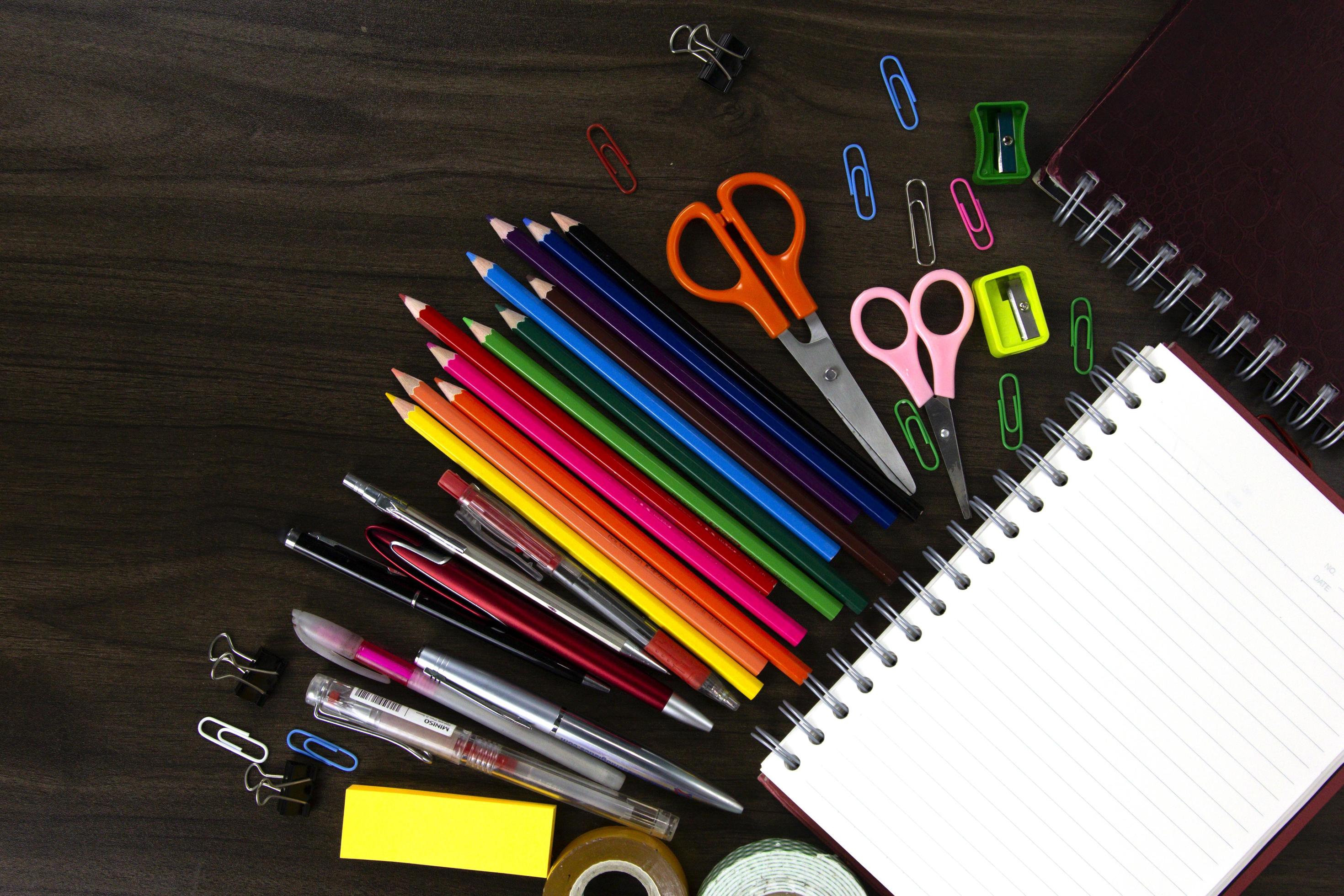 books with color pencils and education elements, back to school concepts on dark wood background Stock Free