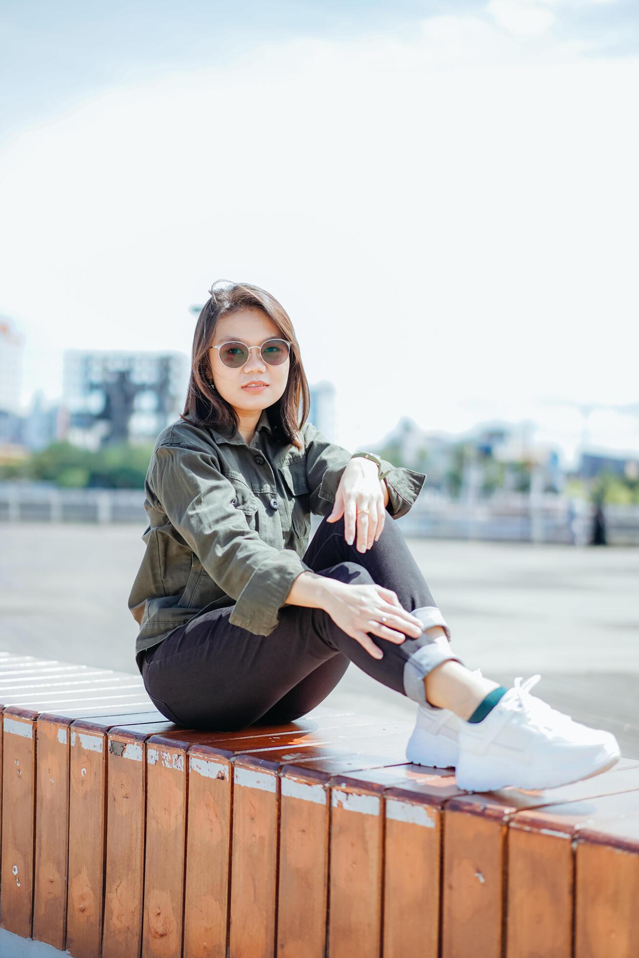 Young Beautiful Asian Woman Wearing Jacket And Black Jeans Posing Outdoors Stock Free