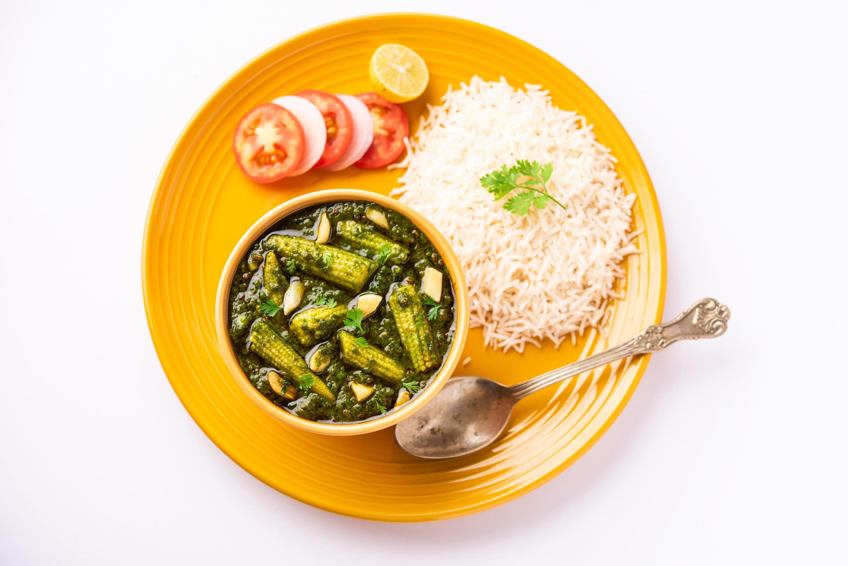 palak baby corn sabzi also known as spinach makai curry served with rice or roti, Indian food Stock Free