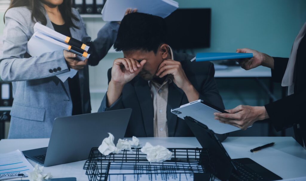 Stressful business man have so many paperwork in the office Stock Free