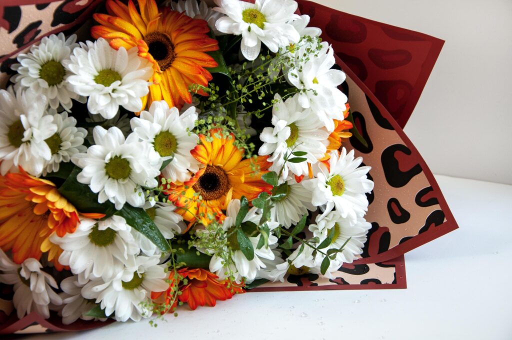 Photo of a bouquet of orange and white flowers on a white background Stock Free