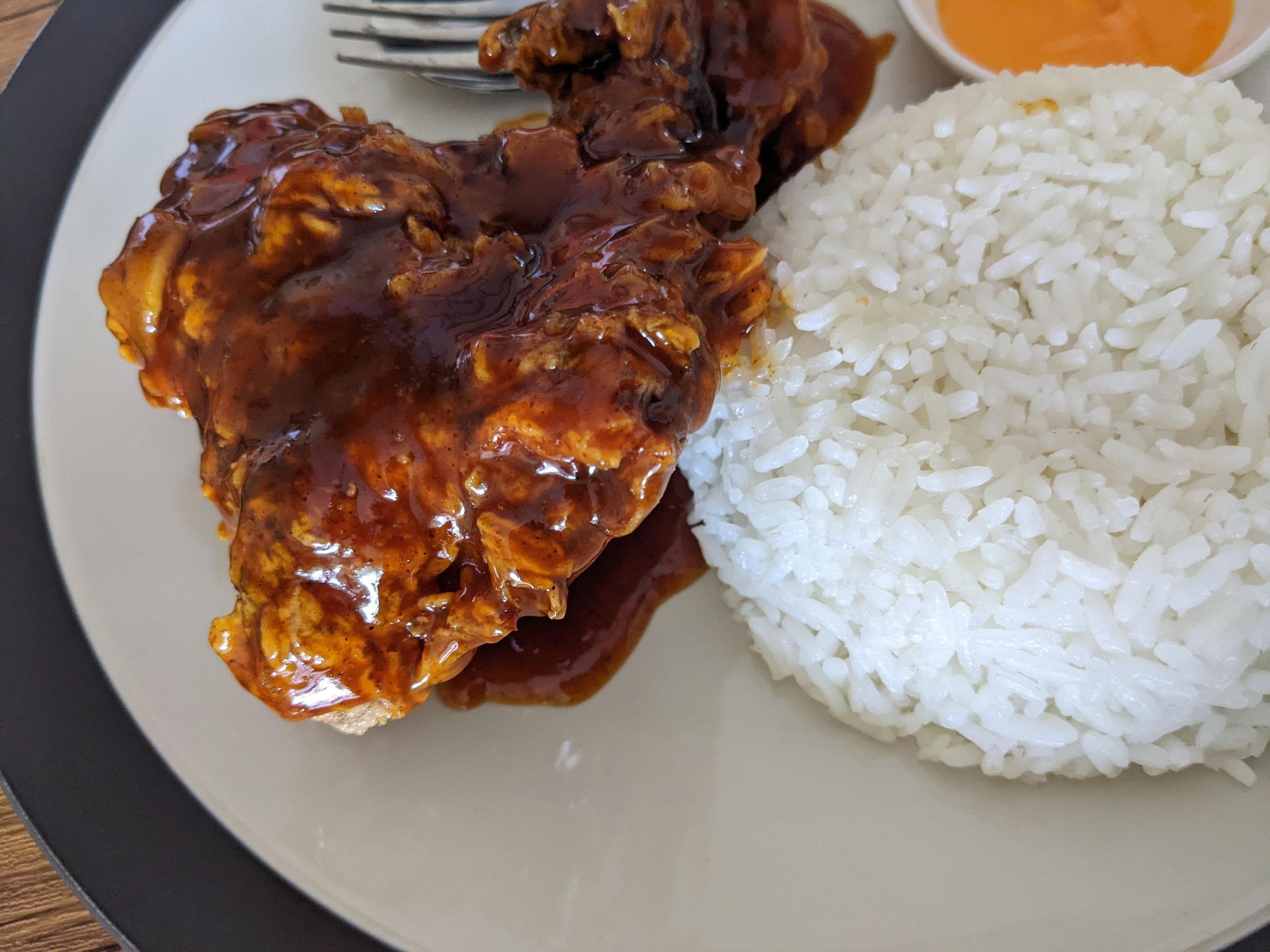 Close up photo of spicy chicken lava with cheese sauce and rice on restaurant. The photo is suitable to use for food background, poster and food content. Stock Free