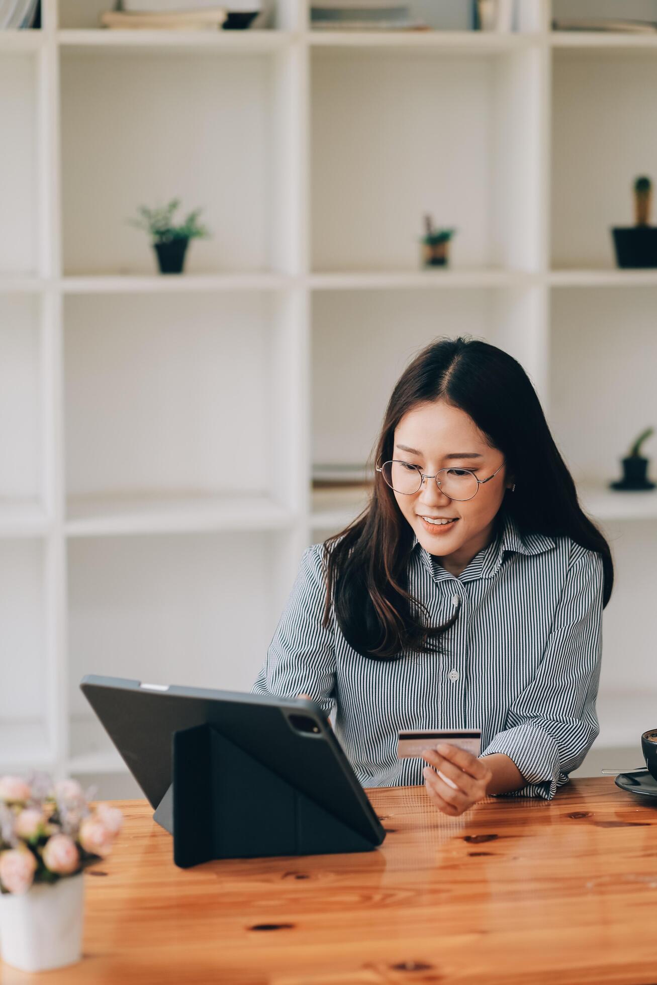 Happy asian woman using smartphone shopping online with credit card. Lifestyle. Easy pay using smart phone or digital device. Stock Free