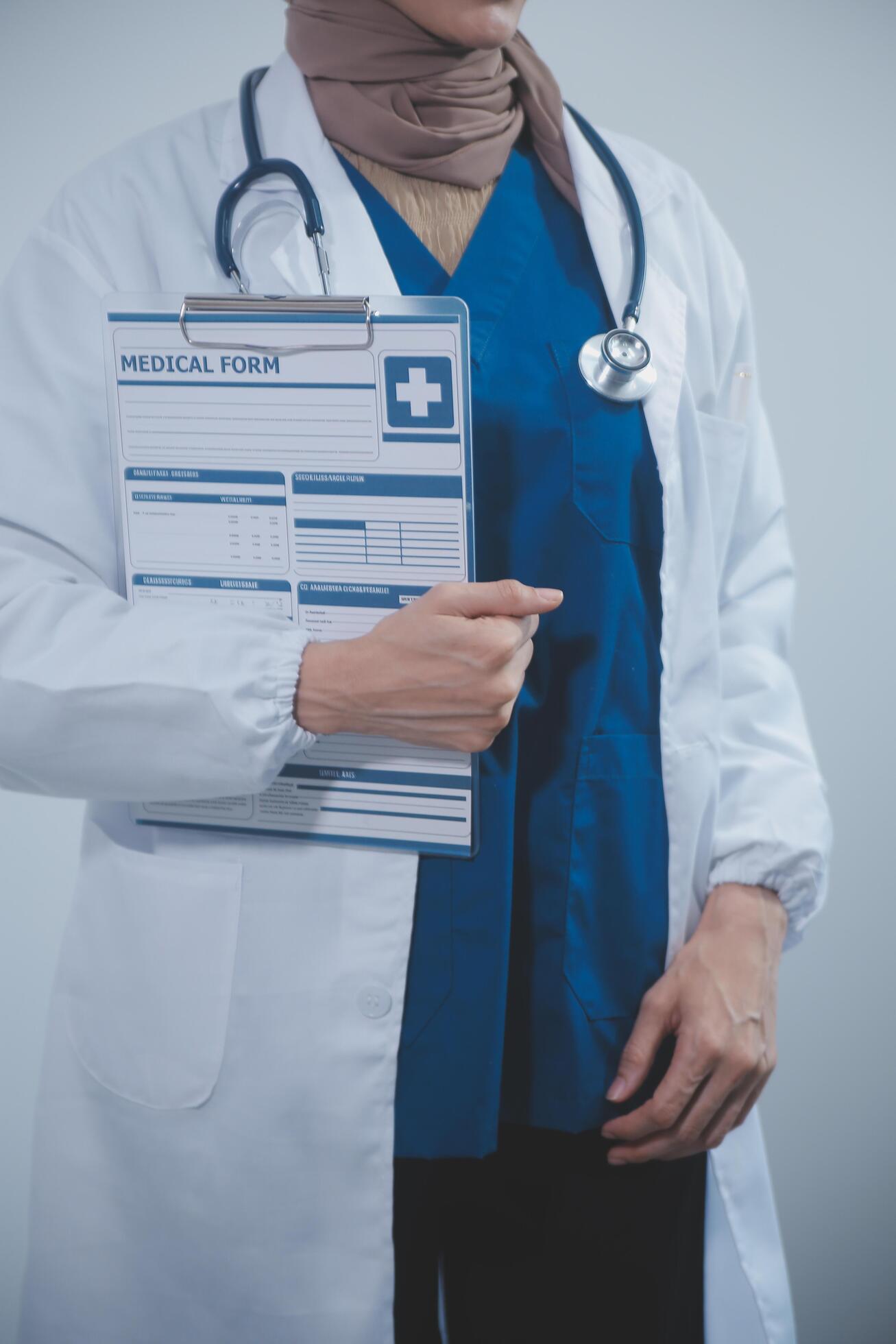 Doctor holding clipboard and stethoscope on background of Hospital ward Stock Free