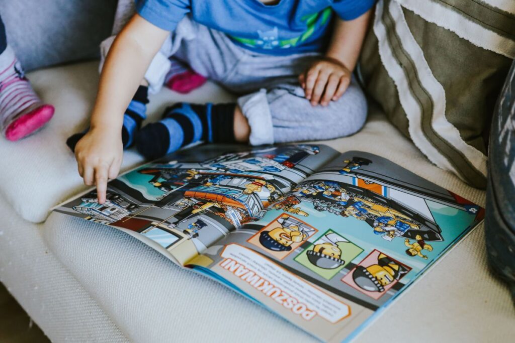 Child reading a comic story Stock Free