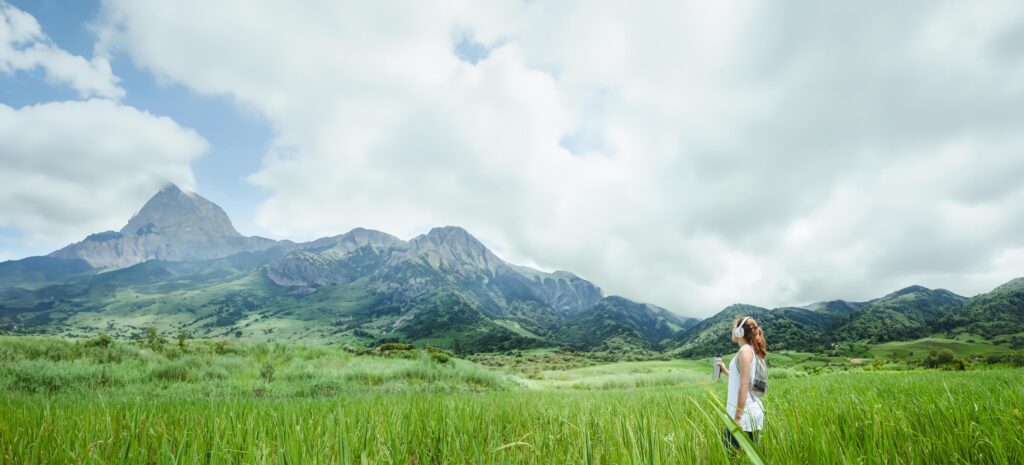 Asian women travel relax in the holiday. Drink Water on a green pasture. Stock Free