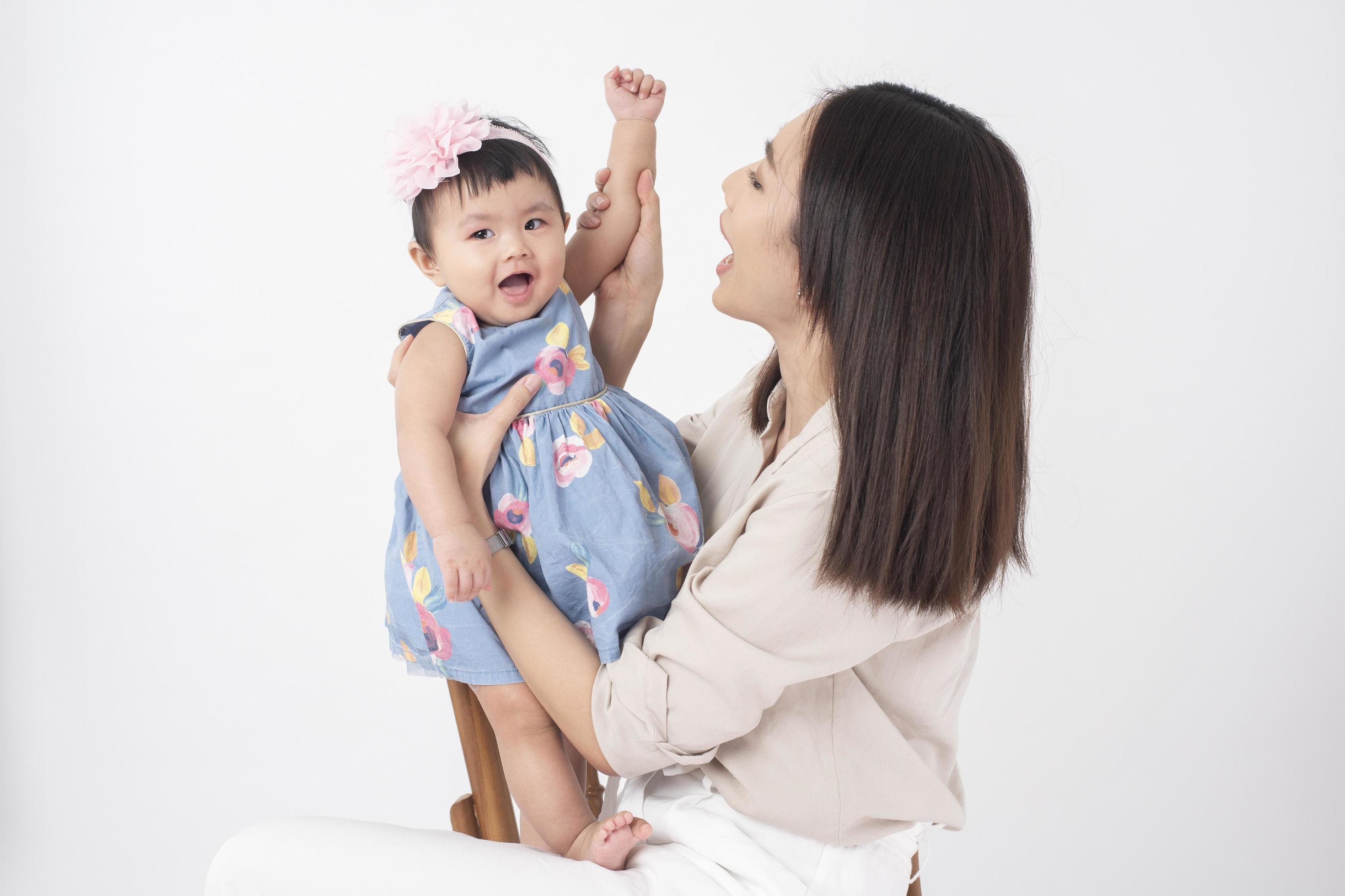 Asian mother and adorable baby girl are happy on white background Stock Free