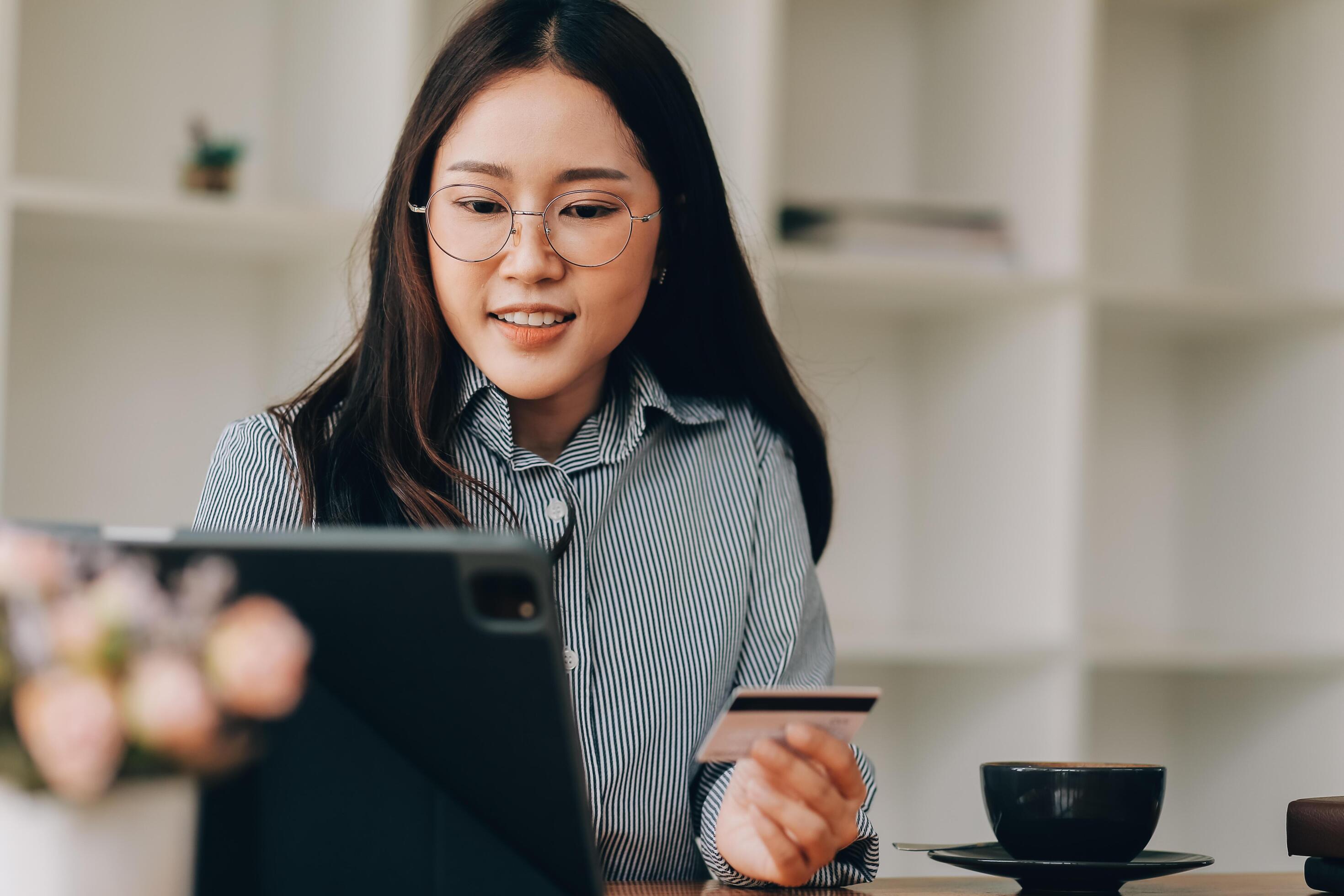 Happy asian woman using smartphone shopping online with credit card. Lifestyle. Easy pay using smart phone or digital device. Stock Free