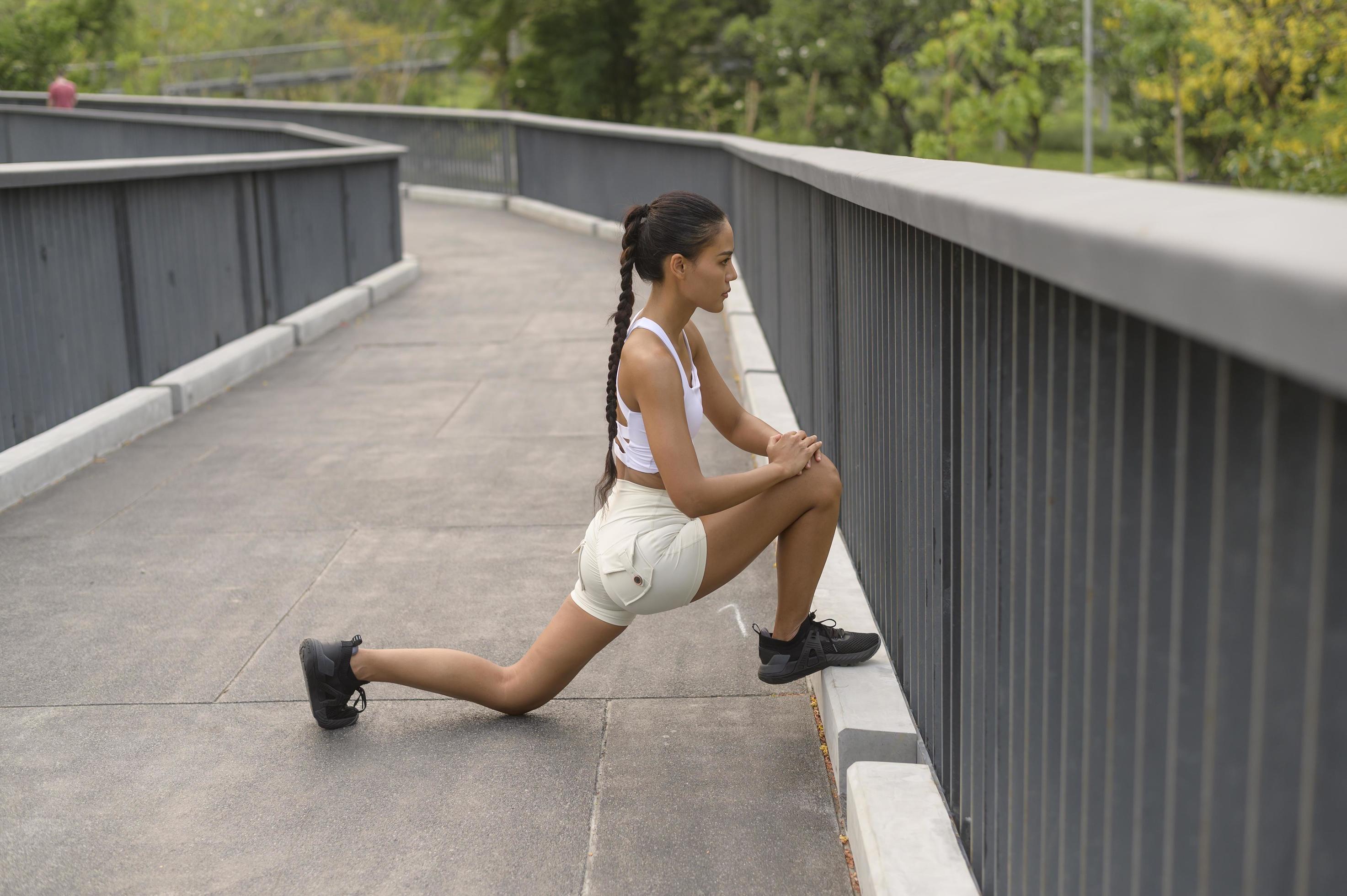 A young fitness woman in sportswear exercising in city park, Healthy and Lifestyles. Stock Free