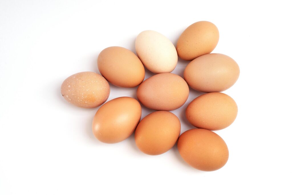 a dozen chicken eggs on a white background. view from above Stock Free