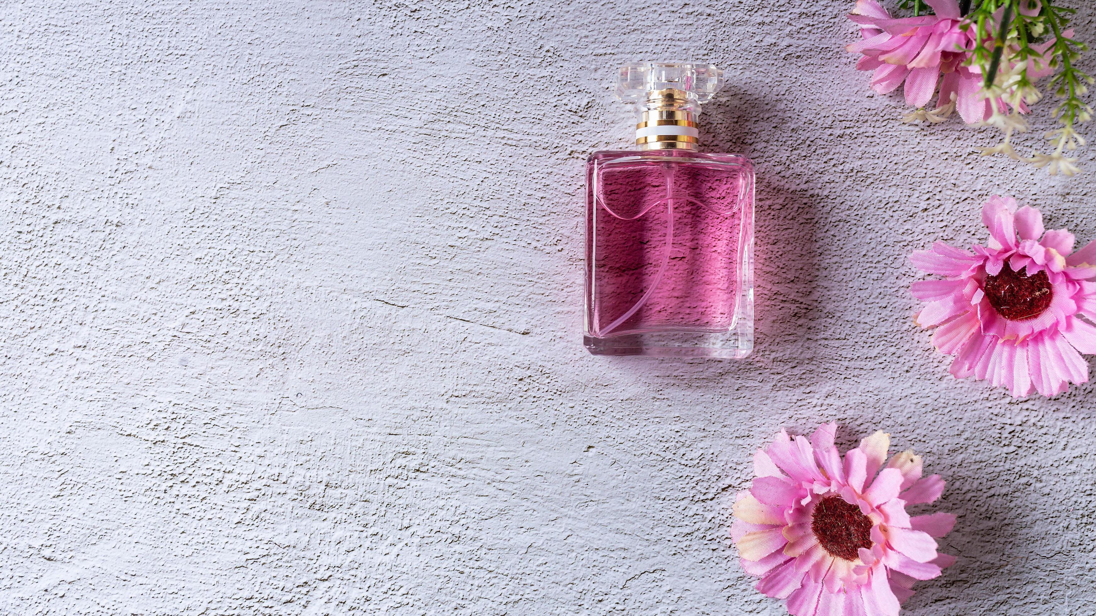 pink perfume bottle with pink flowers Stock Free