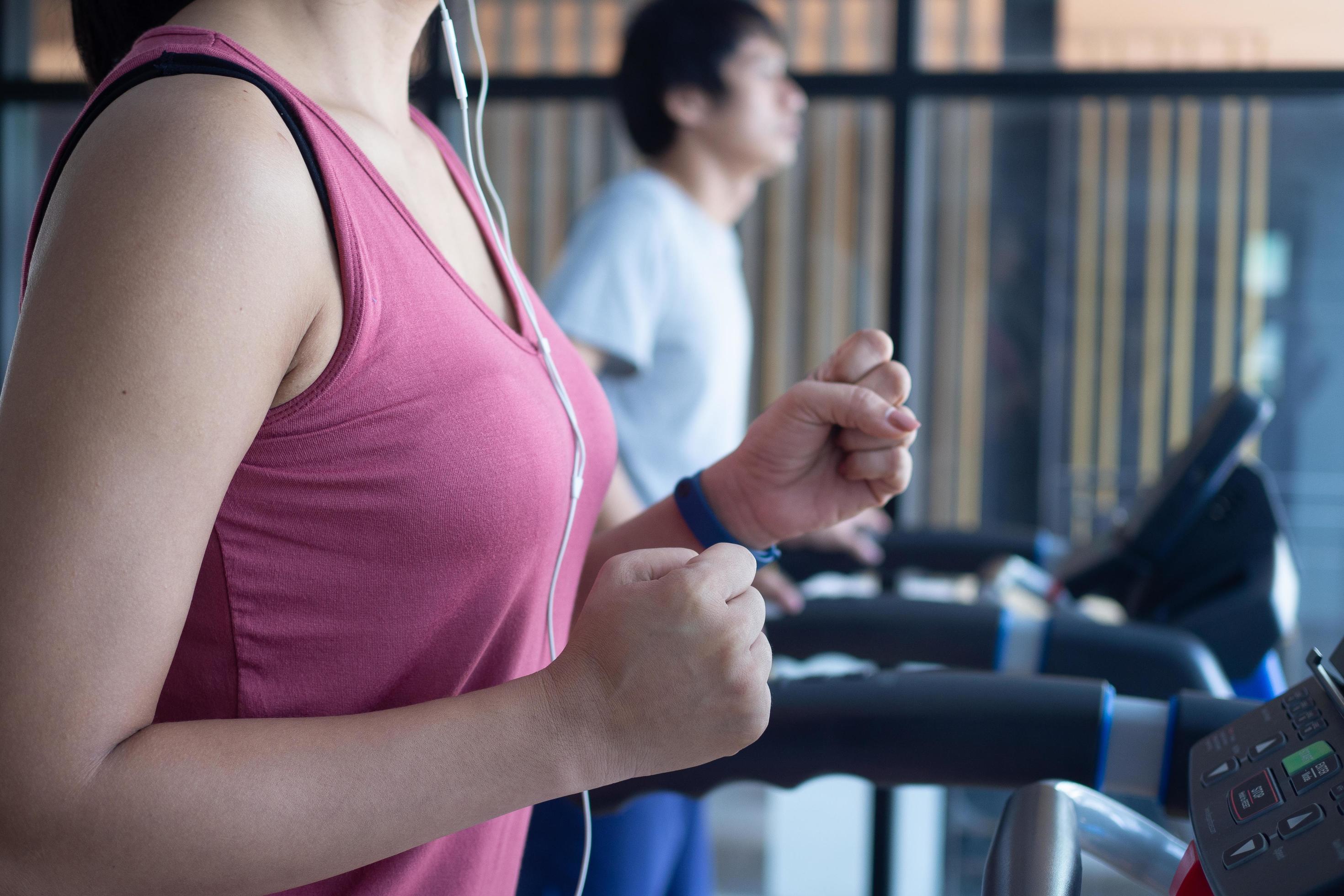 Athletes work out in the fitness room. Healthy people run on a treadmill in the fitness room to exercise. Stock Free