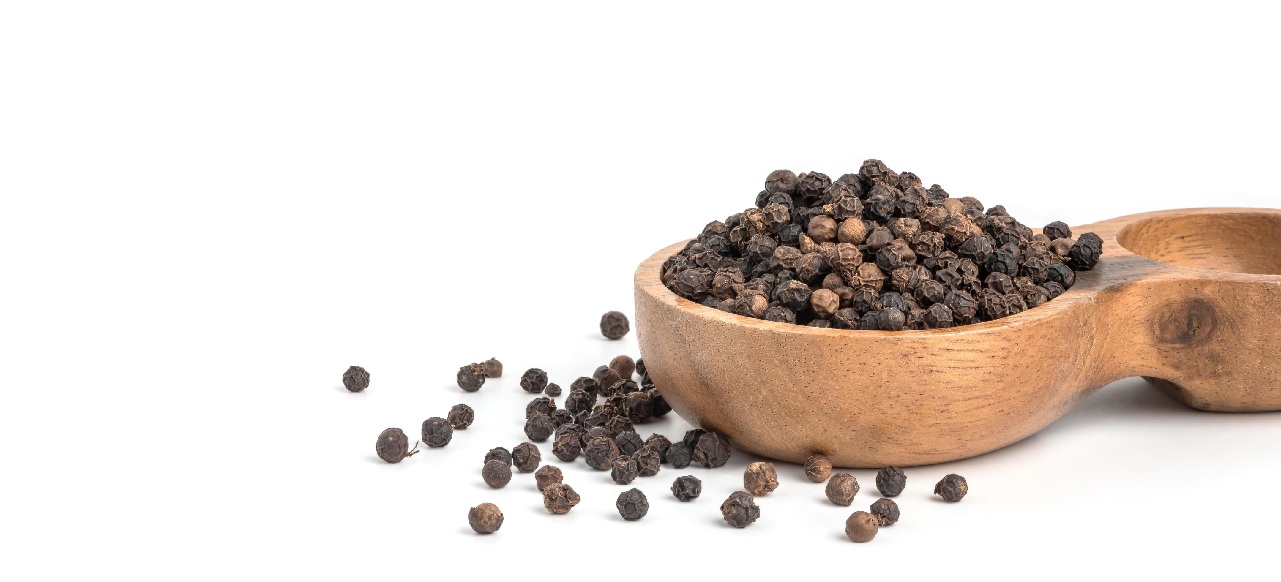 Black pepper seeds on white background. Food ingredients, spices Stock Free