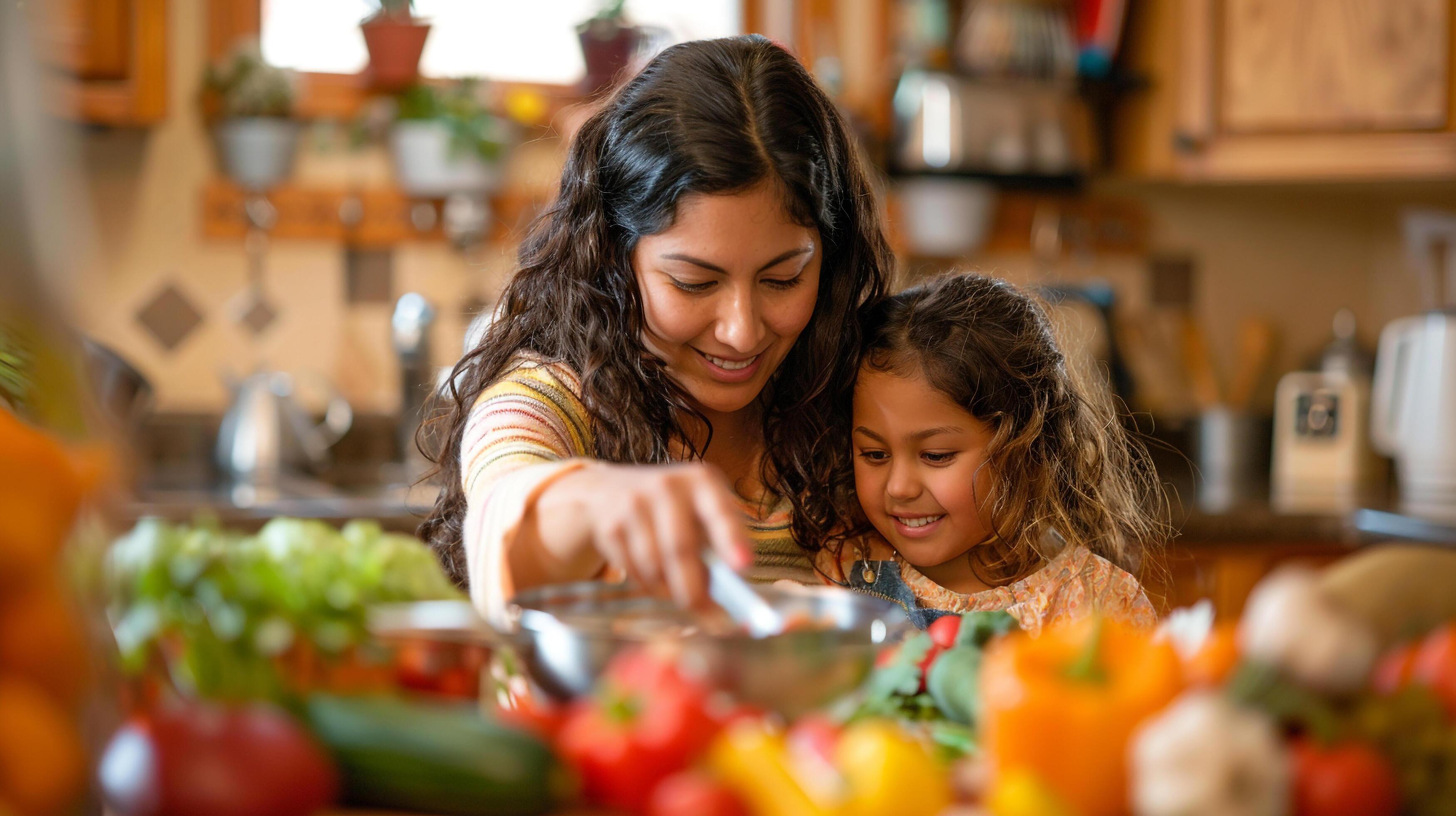 AI generated A mother and daughter cooking a nutritious meal together in the kitchen, family time Stock Free