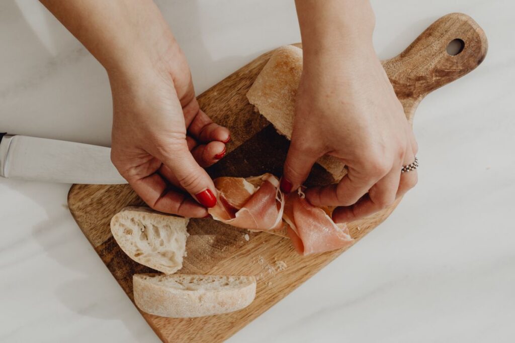 Woman making bruschetta with healthy ingredients Stock Free