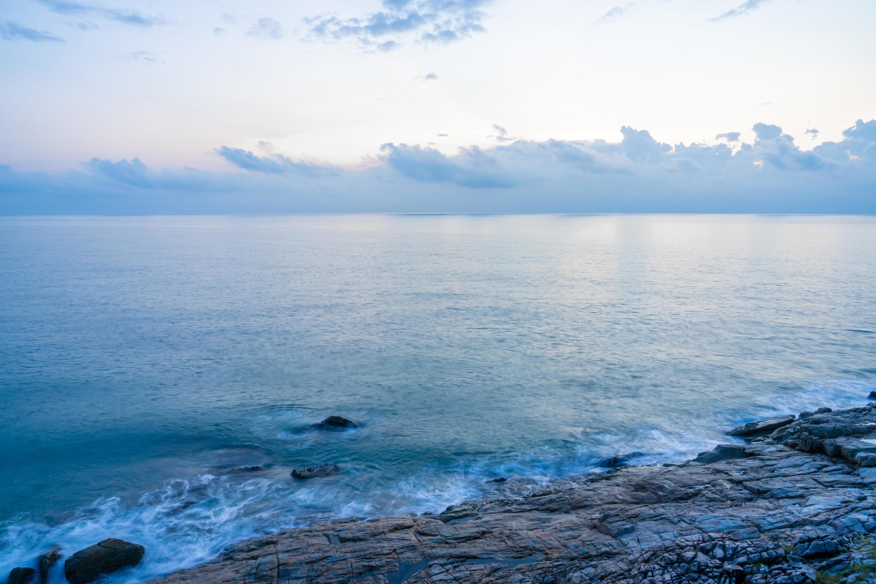 Nature view for soft wave and stone in the sea in morning for background and texture Stock Free