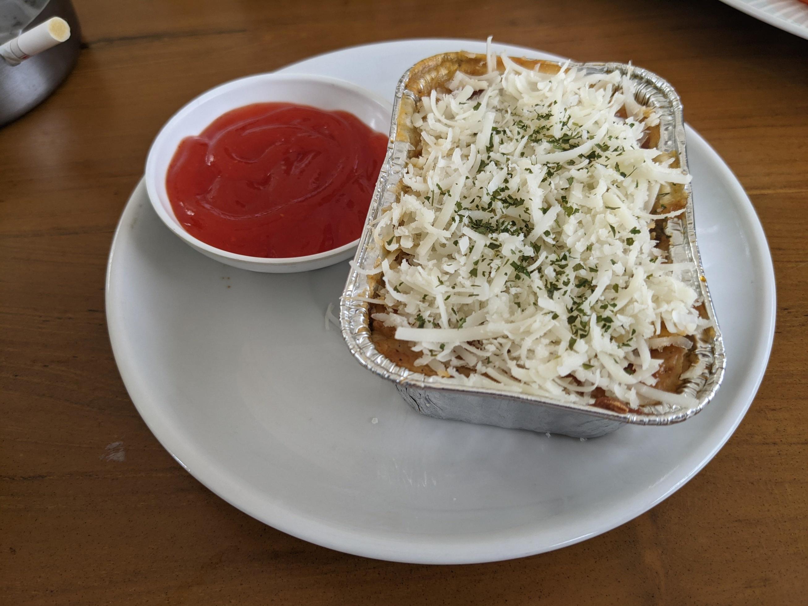 Cedar Cheese and mozzarella on the roasted beef lasagna with chili sauce. The photo is suitable to use for food background, poster and food content media. Stock Free