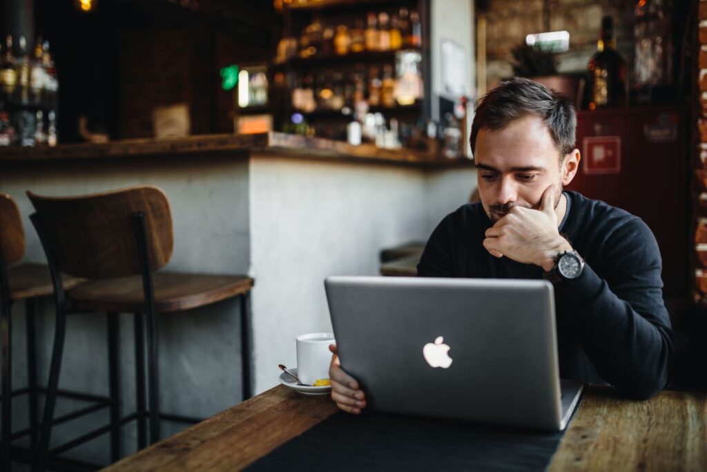 Young Entrepreneur Working from a Modern Cafe Stock Free