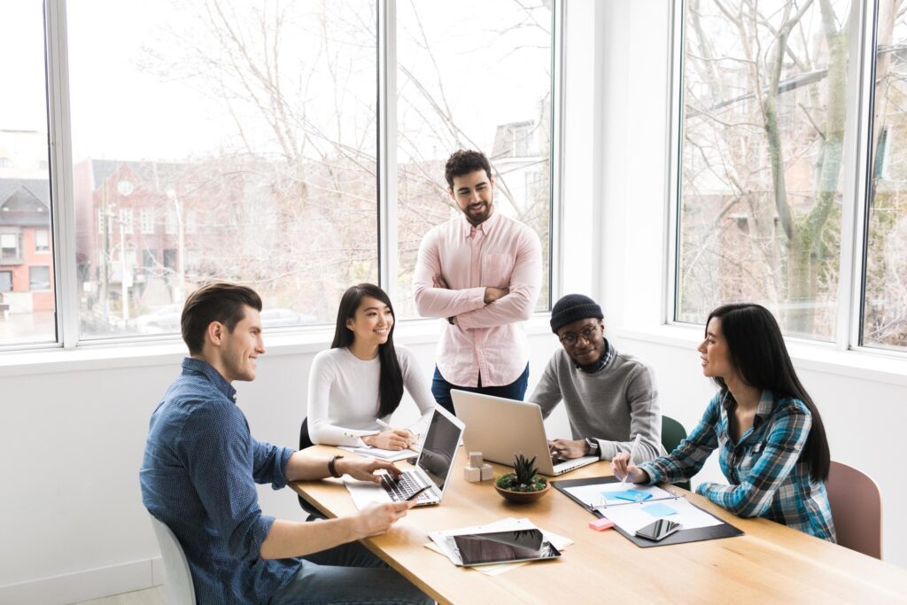 Professionals in a meeting working on laptops Stock Free