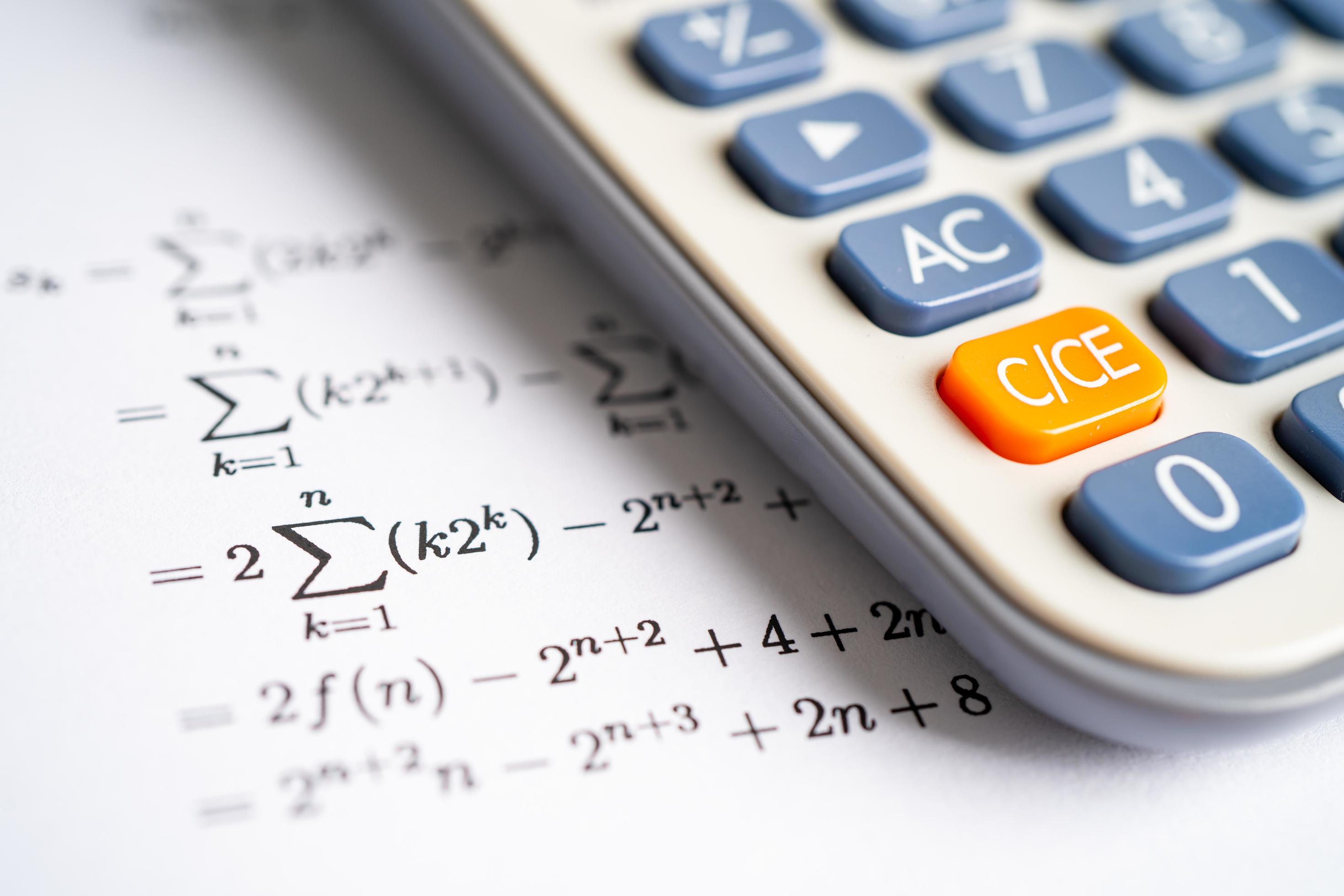 Pencil and calculator on mathematic formula exercise test paper in education school. Stock Free