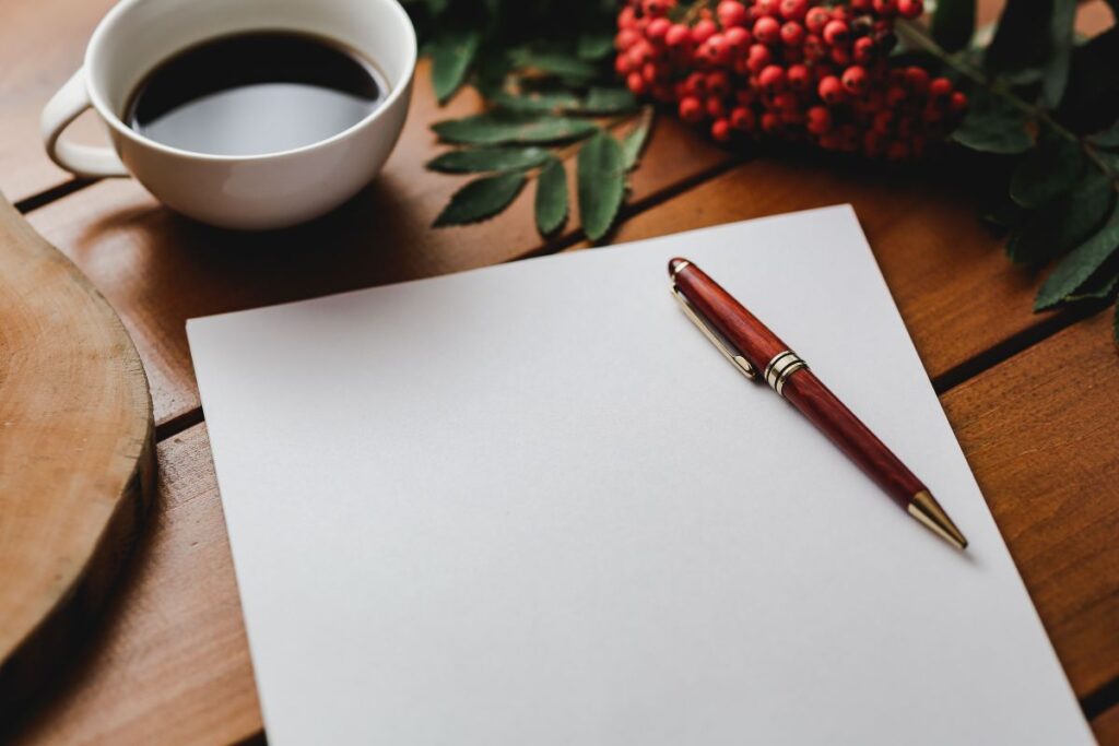 Red rowan fruit with a coffee and a white sheet of paper Stock Free