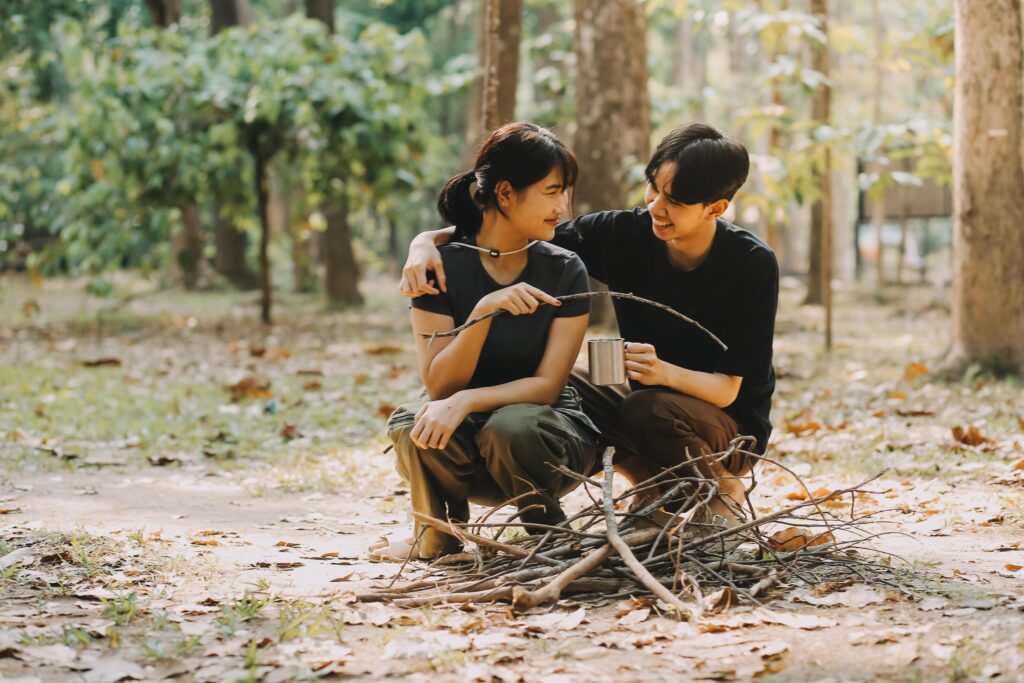 Asian couple sweet in tent inside on they camping trip, traveller relax and sleep togather in out door and camping trip Stock Free