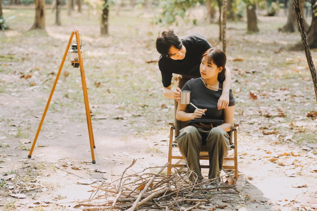 Asian couple sweet in tent inside on they camping trip, traveller relax and sleep togather in out door and camping trip Stock Free