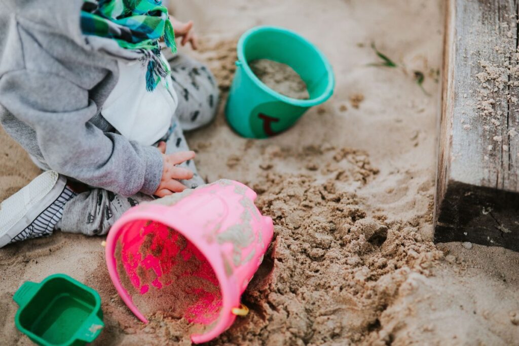 
									Toddler playing in the sand Stock Free