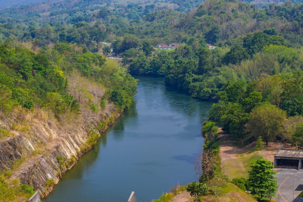 An aerial view of the dam-caused canal in Thailand’s national park, with a mountain the background. Bird eye view. Stock Free