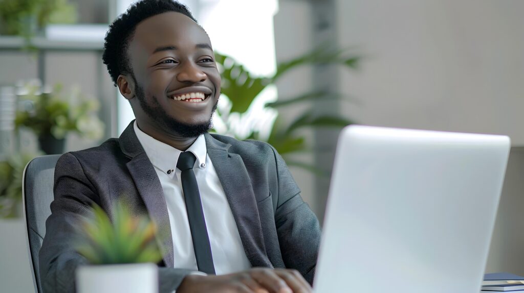 Successful Young Business Executive Happily Working on Laptop in Modern Office Stock Free