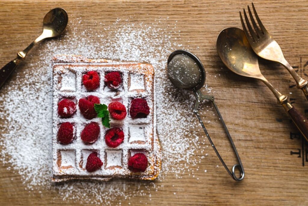 Breakfast waffles with fresh raspberries and powdered sugar Stock Free