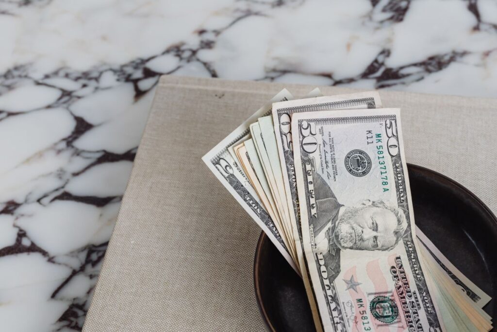 Dollar bills on a marble table Stock Free