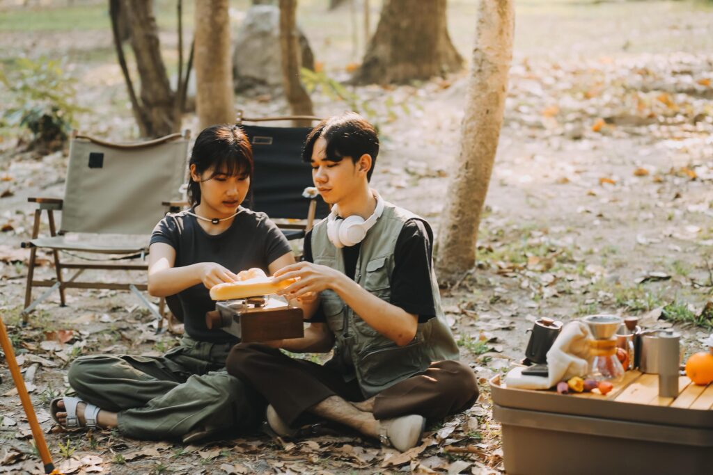 Asian couple sweet in tent inside on they camping trip, traveller relax and sleep togather in out door and camping trip Stock Free