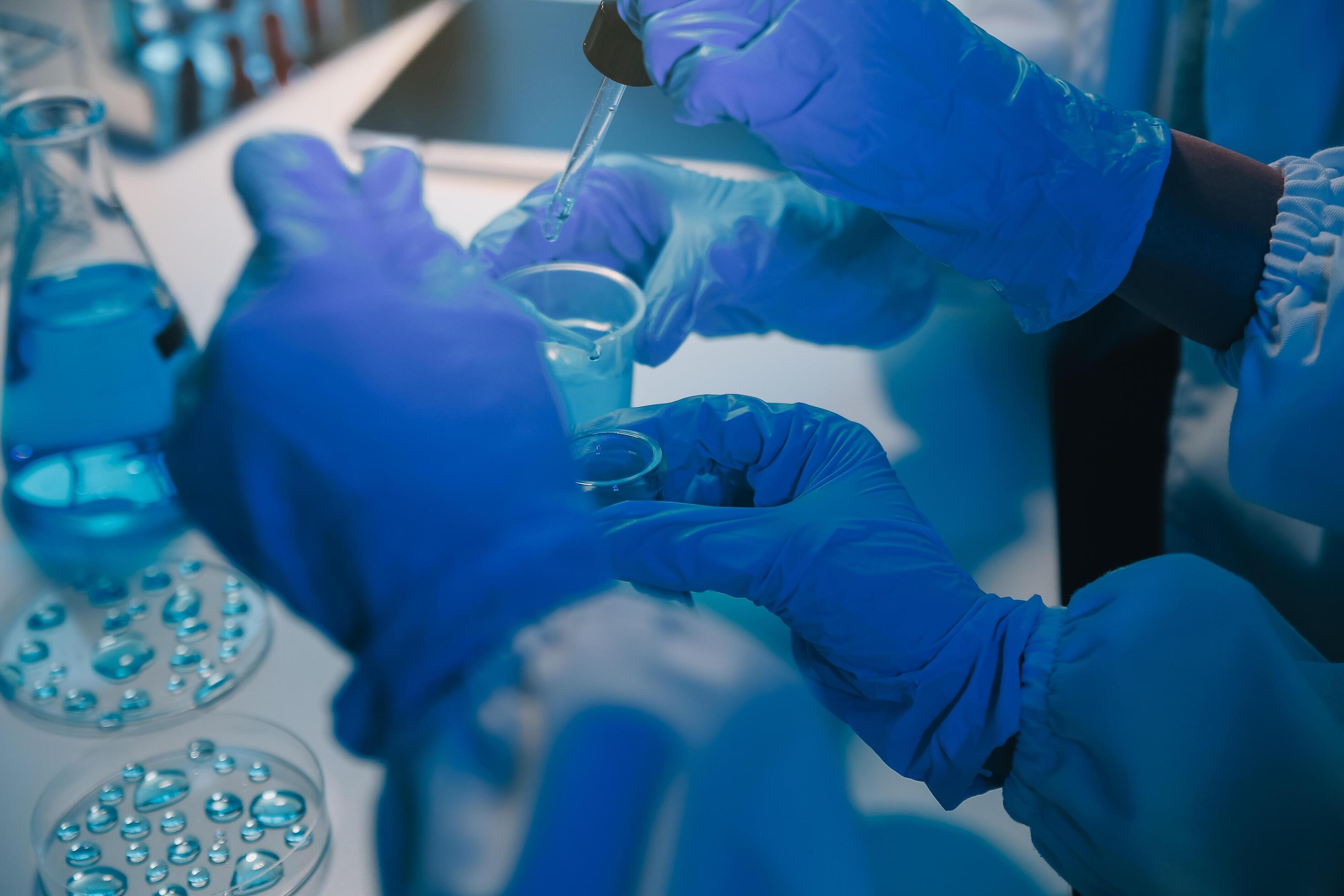 chemist,scientist hand dropping chemical liquid into test tube, science research and development concept Stock Free