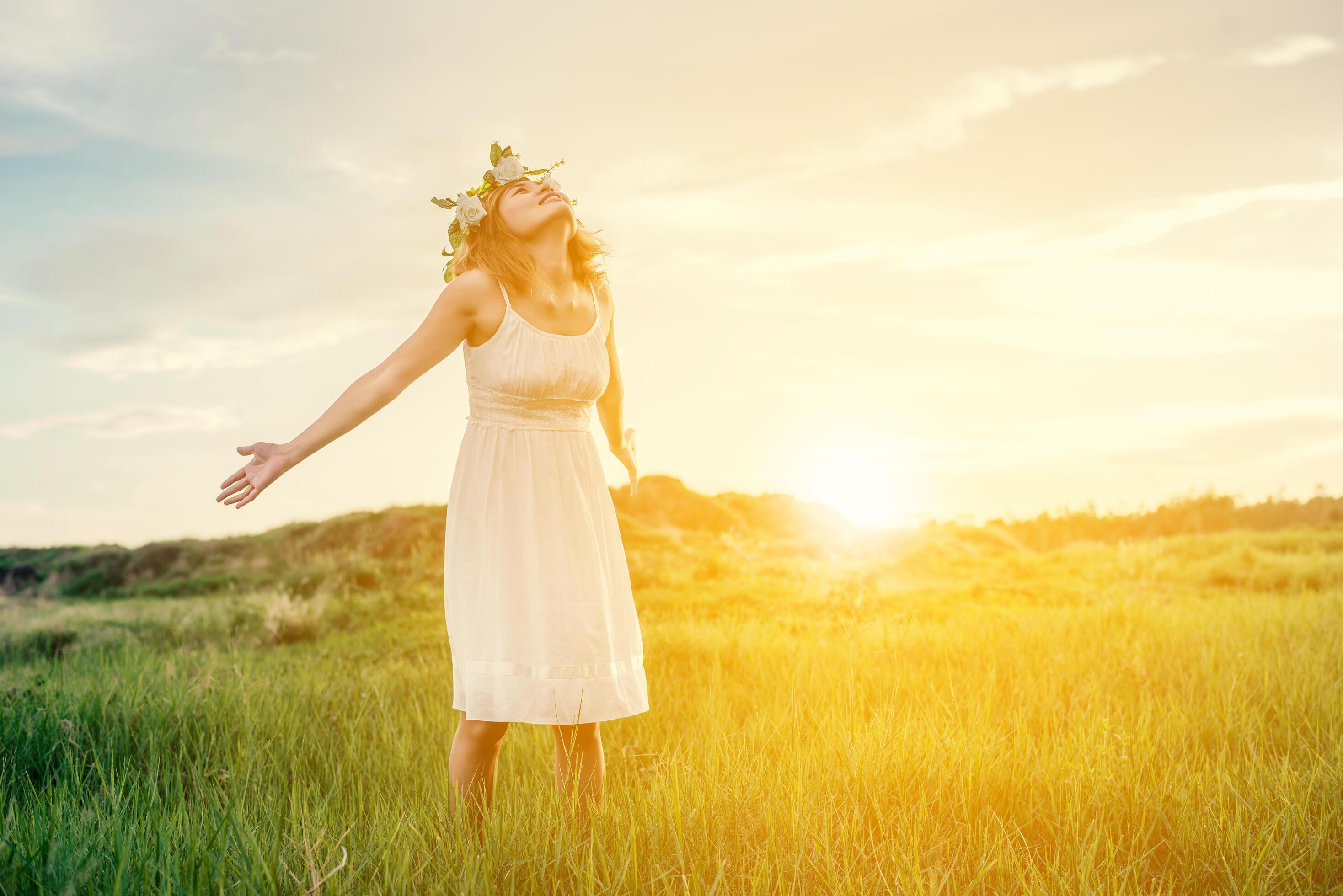 Freedom concept Young beautiful woman enjoying with fresh air and nature at meadows. Stock Free